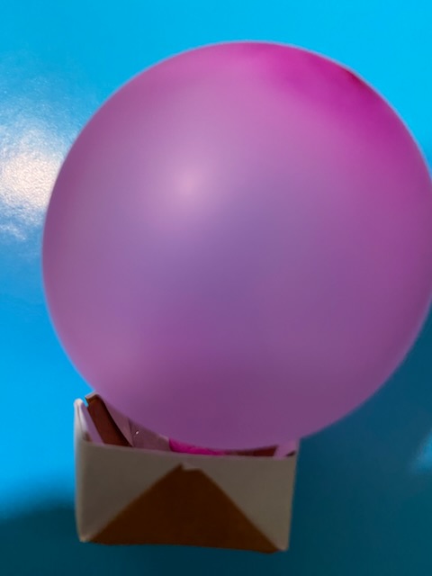 Replica mini balloon attached to paper basket