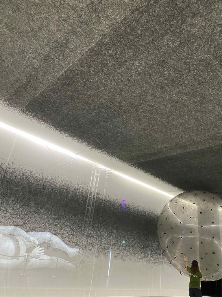 ADA against one wall and ceiling, making contact and leaving charcoal mark imprints