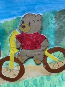 Pooh rides his bicycle downhill.