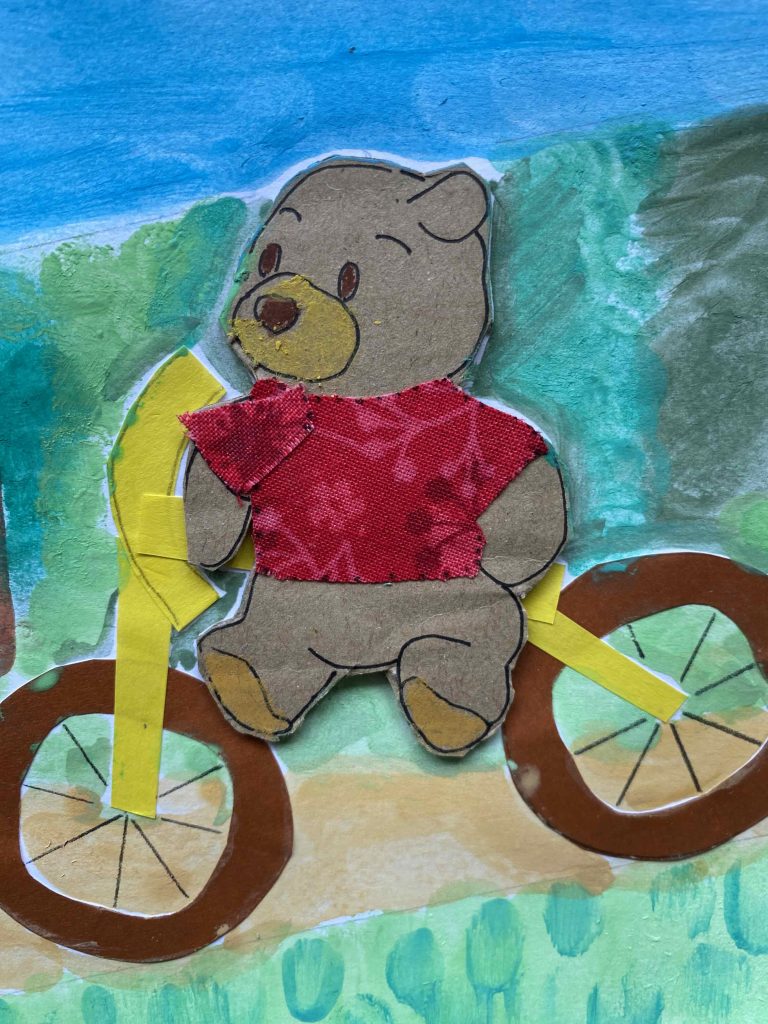 Pooh rides his bicycle downhill. 