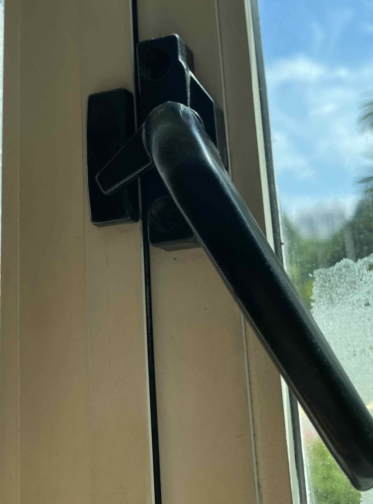 After replacement; new black window handle