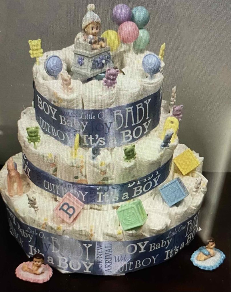 Rolled up hand towels stacked in the shape of a multi-tiered cake, to be given as party flavors.